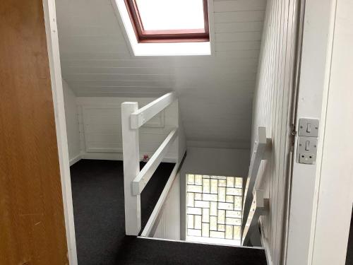 an attic room with a staircase with a skylight at 5 person holiday home in Snedsted in Snedsted