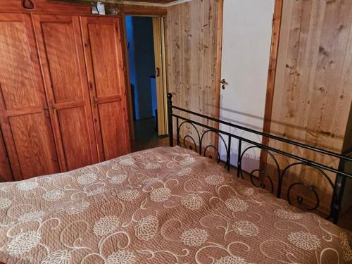 a bedroom with a bed and a wooden door at 4 person holiday home in Föllinge in Föllinge