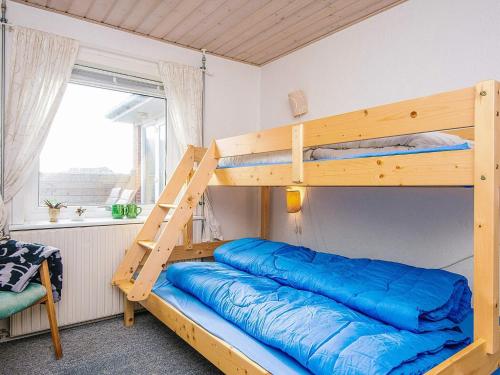 a bedroom with two bunk beds with a ladder at 8 person holiday home in Ulfborg in Ulfborg