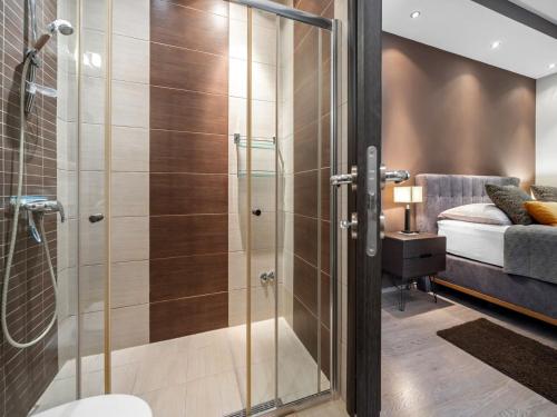 a bathroom with a shower with a glass door at Jacuzzi Retreat in Banjol in Banjol