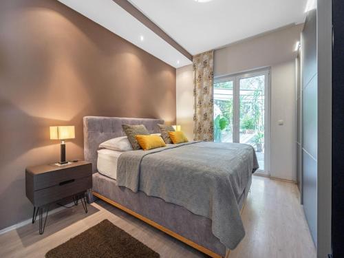 a bedroom with a bed and a window at Jacuzzi Retreat in Banjol in Banjol