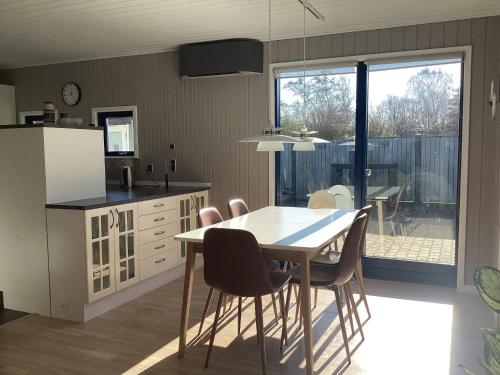 a kitchen with a table and chairs in a room at 8 person holiday home in Nakskov in Nakskov