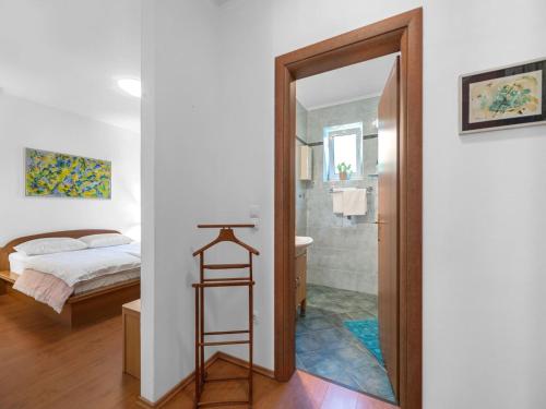 a bedroom with a bed and a bathroom with a shower at Tranquil Escape in Banjol in Banjol