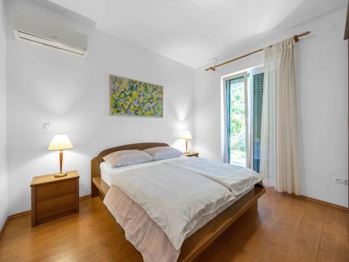 a bedroom with a large bed and a window at Tranquil Escape in Banjol in Banjol