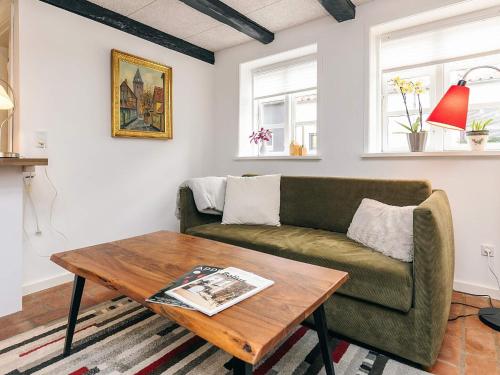 a living room with a couch and a coffee table at 4 star holiday home in Aalborg in Aalborg