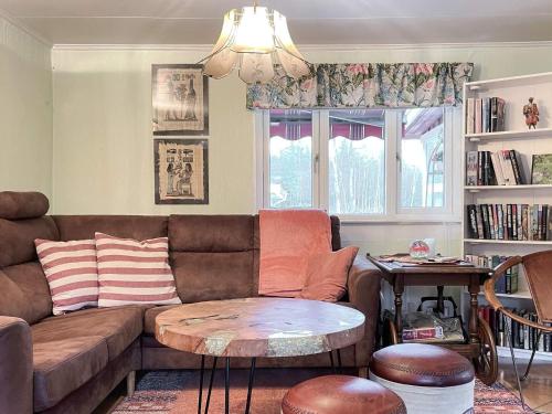a living room with a couch and a table at 10 person holiday home in VITTSJÖ in Vittsjö
