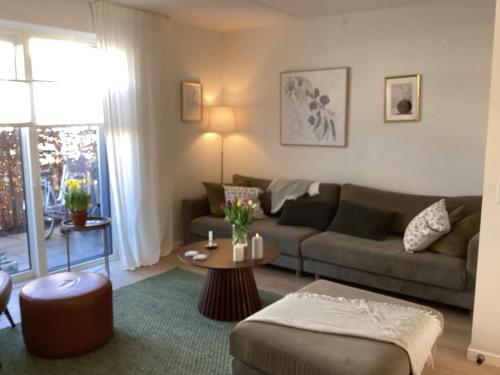 a living room with a couch and a table at 4 star holiday home in Vedbæk in Vedbæk