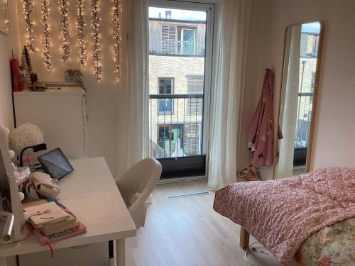 a room with a table and a bed and a window at 4 star holiday home in Vedbæk in Vedbæk