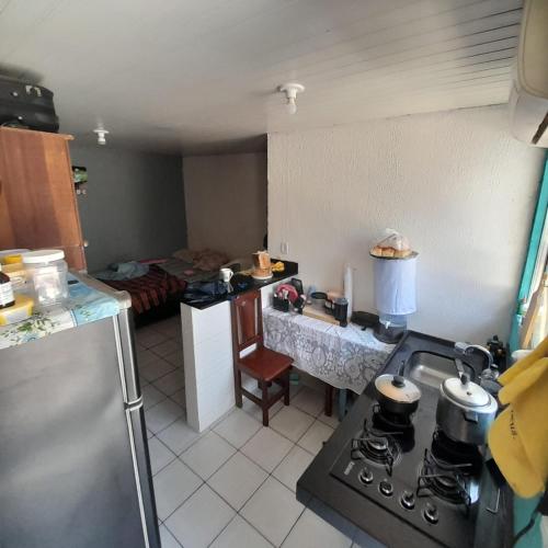 a kitchen with a sink and a stove top oven at São bras casa in Belém
