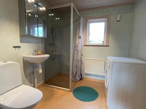 a bathroom with a shower and a toilet and a sink at 4 person holiday home in FäRJESTADEN in Färjestaden