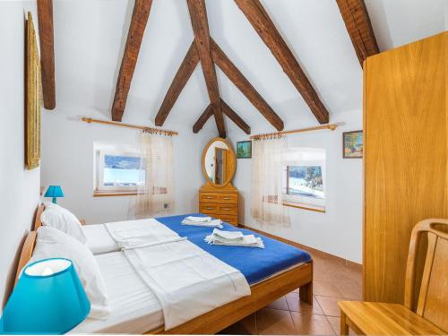 a bedroom with a bed and a mirror in it at Holiday Home near Beach in Croatia in Cres