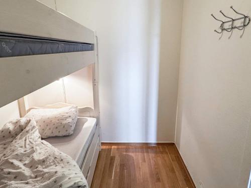 a bedroom with a bunk bed and a wooden floor at 4 star holiday home in HOVDEN in Hovden