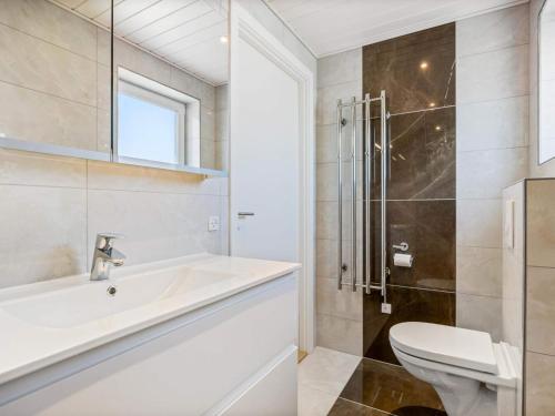 a bathroom with a sink and a toilet and a shower at 4 star holiday home in Nørre Nebel in Nørre Nebel
