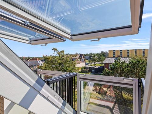 a balcony with a large window with a view at 4 star holiday home in Nørre Nebel in Nørre Nebel
