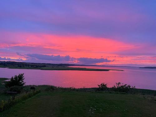 a sunset over a large body of water at 5 star holiday home in Løgstrup in Løgstrup