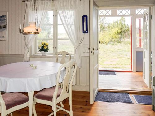 a dining room with a white table and chairs at 6 person holiday home in OSKARSHAMN in Oskarshamn