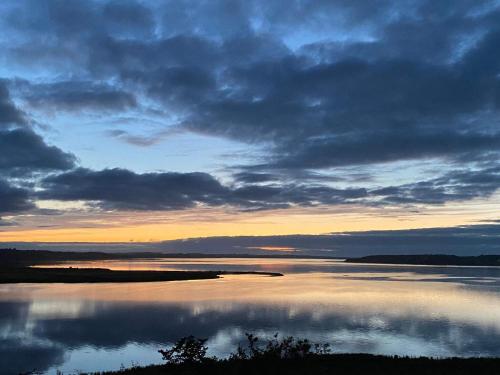 a view of a large body of water at sunset at 5 star holiday home in Løgstrup in Løgstrup