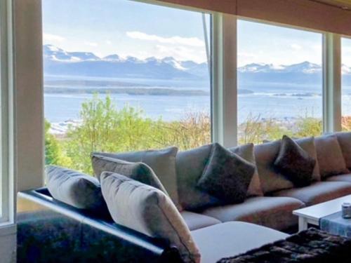 a couch in a room with a large window at 7 person holiday home in Molde in Molde
