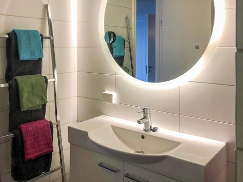 a bathroom with a sink and a mirror and towels at 7 person holiday home in Molde in Molde