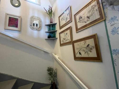 a staircase with framed pictures on the wall at 6 person holiday home in VIMMERBY in Vimmerby