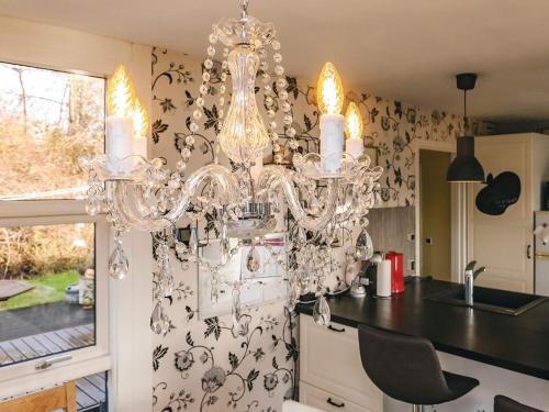 a kitchen with a chandelier hanging from the ceiling at 4 person holiday home in Vordingborg in Vordingborg