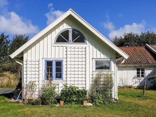 a white house with a window on top of it at 4 star holiday home in Åsa in Åsa