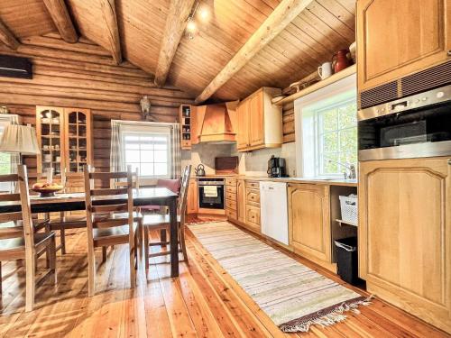 a kitchen with wooden cabinets and a table and chairs at 4 star holiday home in gol in Gol