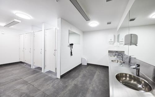 a bathroom with two sinks and white cabinets at The Bealey Quarter in Christchurch