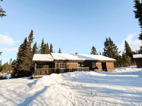 a log cabin with snow on the ground at 4 star holiday home in gol in Gol