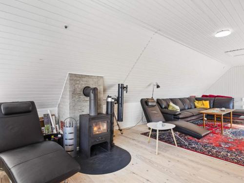 a living room with a fireplace and a couch at 4 star holiday home in Nørre Nebel in Nørre Nebel