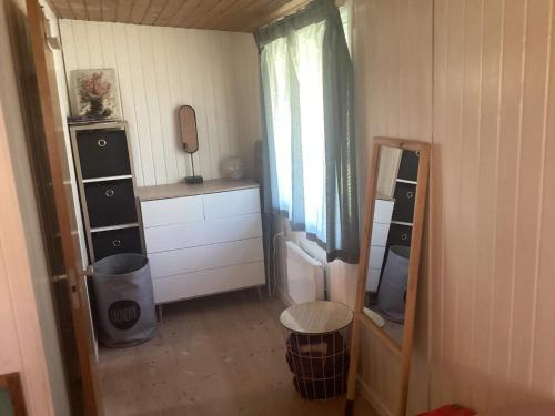 a small room with a mirror and a dresser at 6 person holiday home in Dannemare in Dannemare