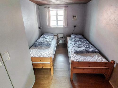 two beds in a small room with a window at 8 person holiday home in Svendborg in Svendborg