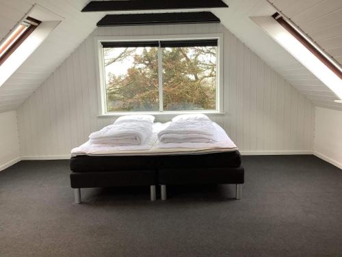 a bed in a room with a window at 5 person holiday home in Snedsted in Snedsted