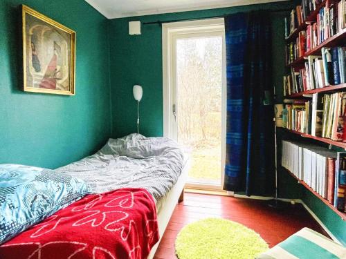 a bedroom with a bed and a book shelf with books at 4 star holiday home in FRÄNDEFORS in Frändefors