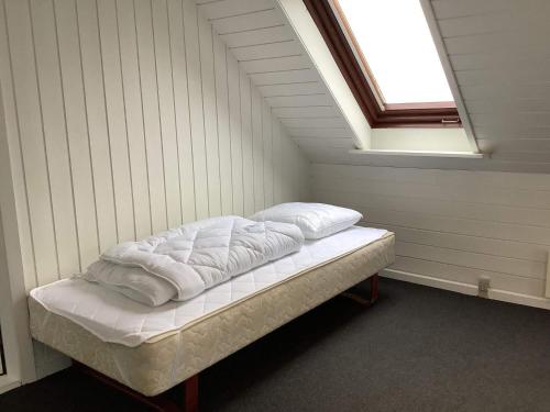 a small bed in a room with a window at 5 person holiday home in Snedsted in Snedsted