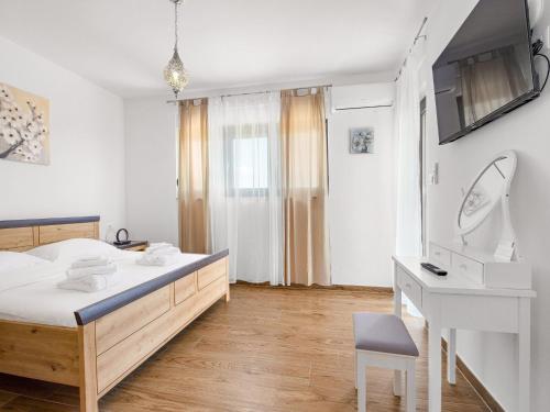 a bedroom with a bed and a sink and a desk at Villa in Krnica with Pool near Rock Beach in Krnica