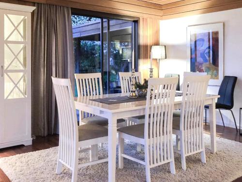 a white dining room table with white chairs around it at 7 person holiday home in Molde in Molde