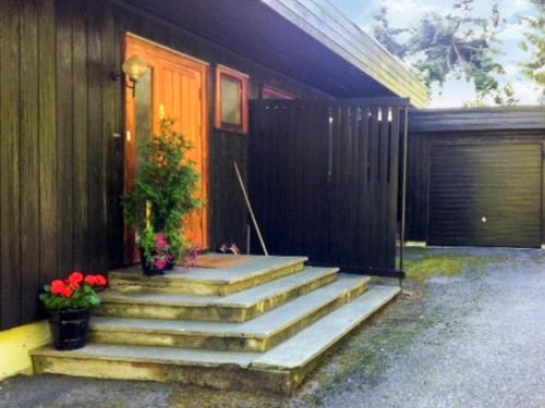 a house with stairs leading to a door with flowers at 7 person holiday home in Molde in Molde