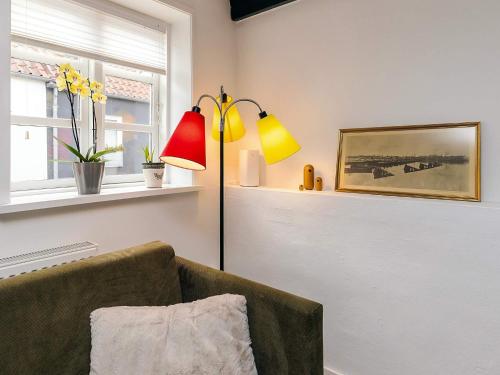 a living room with a lamp and a couch at 4 star holiday home in Aalborg in Aalborg
