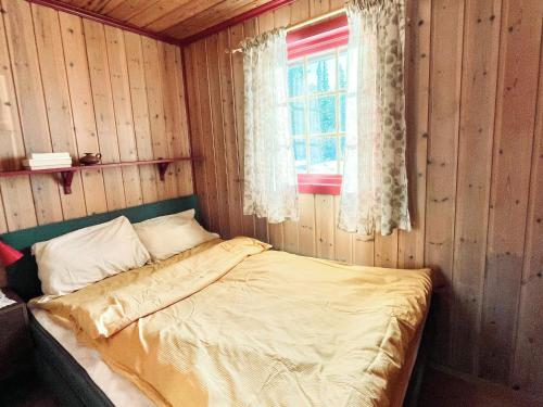 a bedroom with a bed in a room with a window at 4 person holiday home in gol in Gol