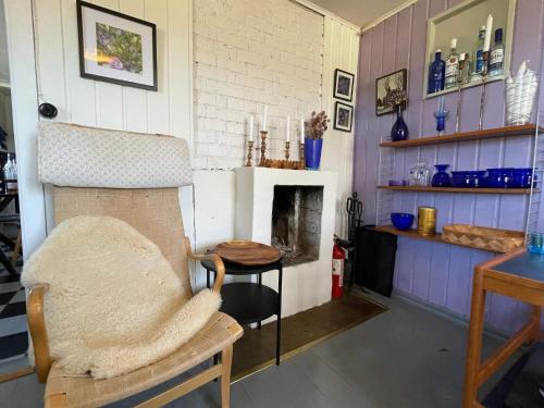 a living room with a table and a fireplace at 6 person holiday home in VIMMERBY in Vimmerby