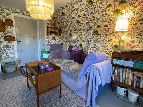 a living room with a couch and a table at 6 person holiday home in VIMMERBY in Vimmerby