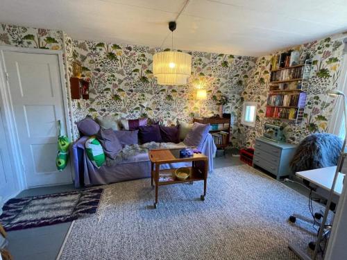 a living room with a couch and a table at 6 person holiday home in VIMMERBY in Vimmerby