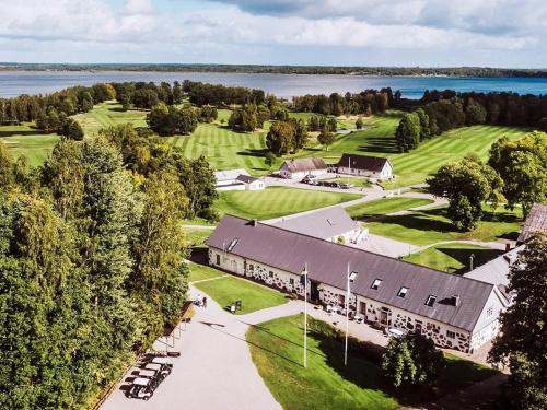 an aerial view of a large building with a golf course at 10 person holiday home in VITTSJÖ in Vittsjö
