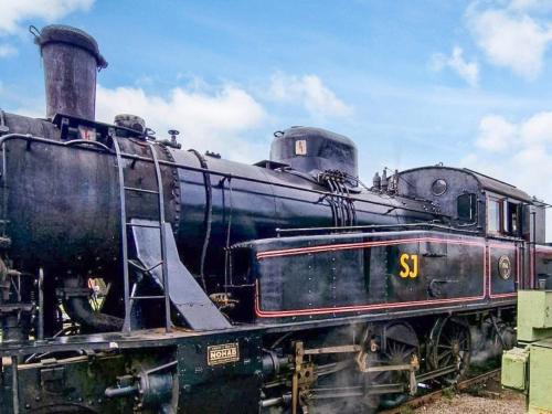 an old black train is sitting on the tracks at 10 person holiday home in VITTSJÖ in Vittsjö