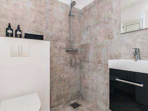 a bathroom with a shower and a toilet and a sink at 5 star holiday home in Liseleje in Liseleje