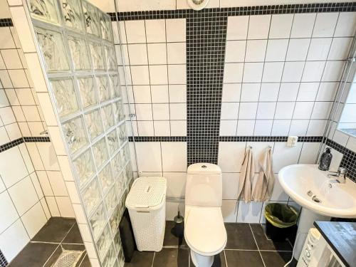 a bathroom with a toilet and a sink at 4 person holiday home in ANDERSLÖV in Anderslöv