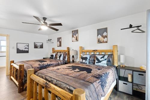 a bedroom with two beds and a ceiling fan at Glacier Run, Hot Tub, Sauna,Movie Theater, WiFi, EV in Ashford