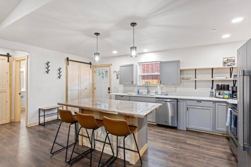a kitchen with a large wooden table and chairs at Glacier Run, Hot Tub, Sauna,Movie Theater, WiFi, EV in Ashford
