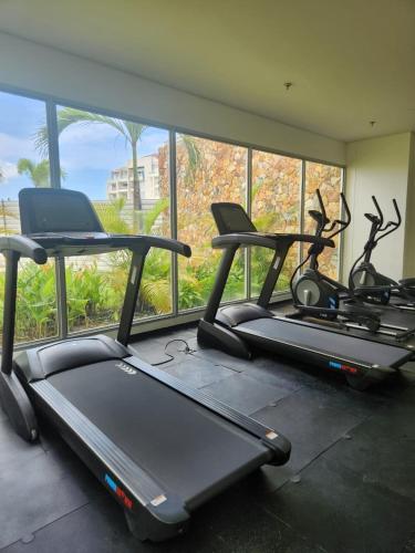 a gym with three treadmills in front of a window at Con jacuzzi privado, laguna y Paddle board in Cartagena de Indias